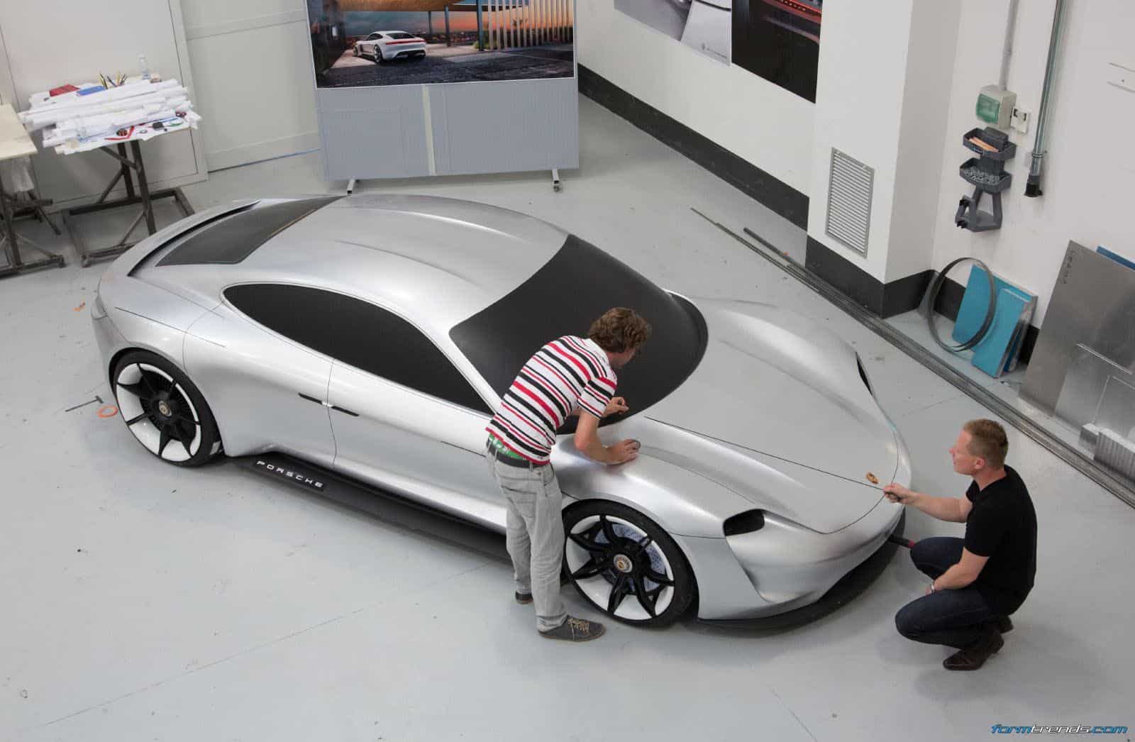 Exterior designer Emiel Burki and exterior design chief Mitja Borkert with a full-size model of the Porsche Mission E